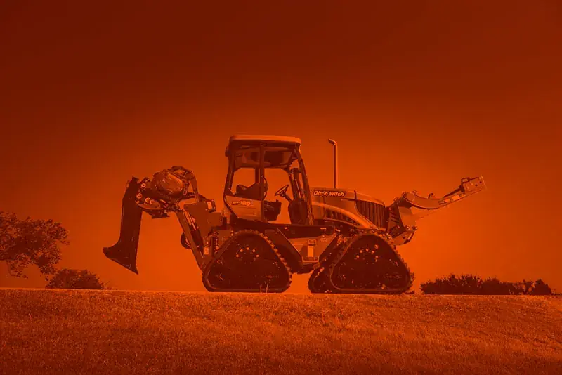 Four O Six Underground track plow and trencher on a hillside cable route