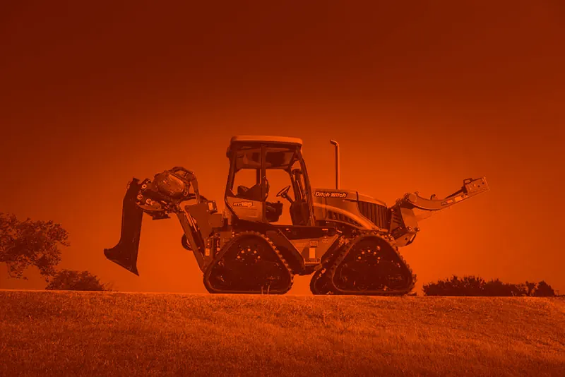 Track plow and trencher on a hillside